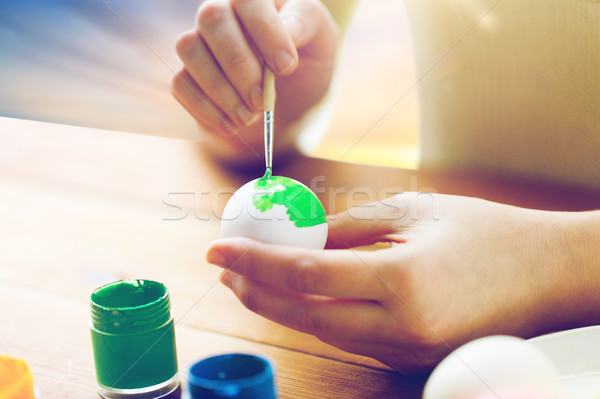 close up of woman hands coloring easter eggs Stock photo © dolgachov