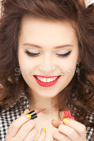 beautiful woman polishing her nails Stock photo © dolgachov