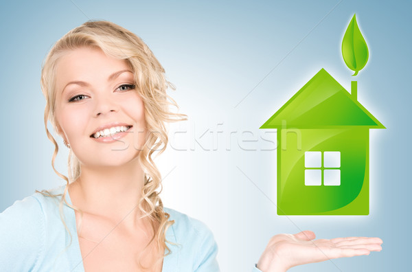 woman holding green house in her hands Stock photo © dolgachov