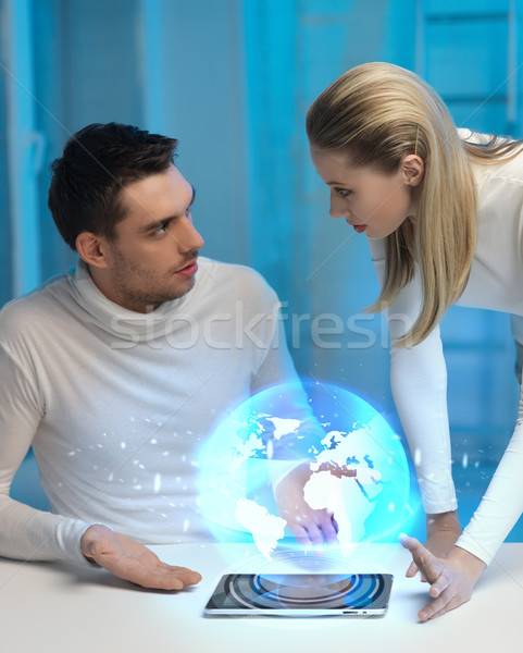 Futurisztikus férfi nő földgömb hologram kép Stock fotó © dolgachov