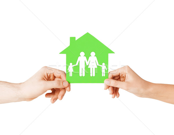 Stock photo: hands holding green house with family