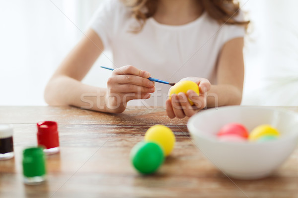 close up of girl coloring eggs for easter Stock photo © dolgachov