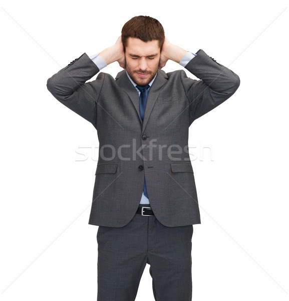 annoyed businessman covering ears with his hands Stock photo © dolgachov