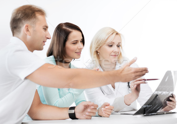 doctor with patients looking at x-ray Stock photo © dolgachov