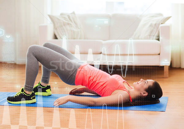 smiling girl doing exercise for legs and buttocks Stock photo © dolgachov