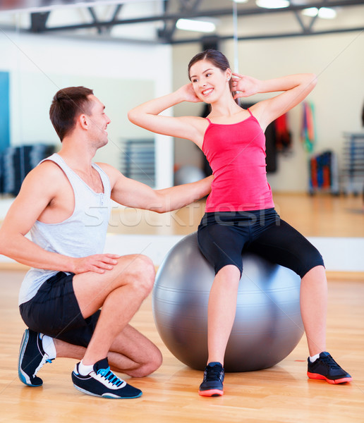 male trainer with woman doing crunches on the ball Stock photo © dolgachov