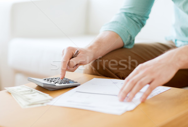 close up of man counting money and making notes Stock photo © dolgachov