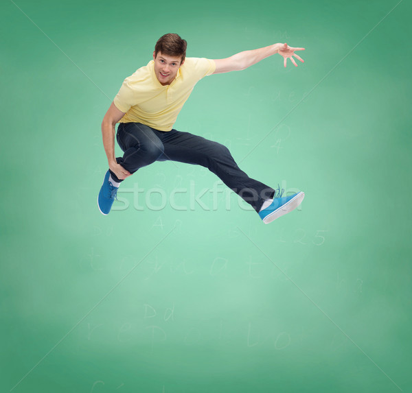 smiling young man jumping in air Stock photo © dolgachov