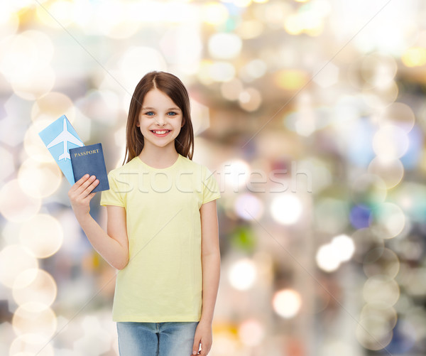smiling little girl with ticket and passport Stock photo © dolgachov