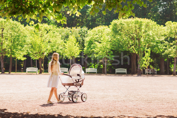 happy mother with stroller in park Stock photo © dolgachov