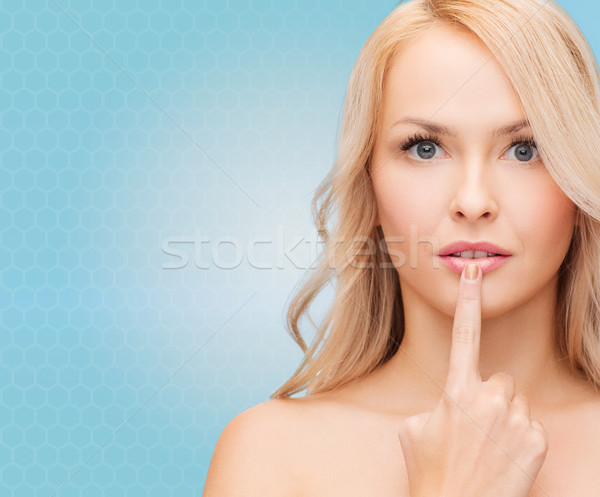 beutiful young woman touching her lips Stock photo © dolgachov