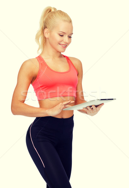 smiling sporty woman with tablet pc computer Stock photo © dolgachov