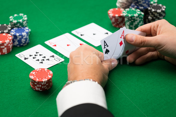 Stock photo: poker player with cards and chips at casino