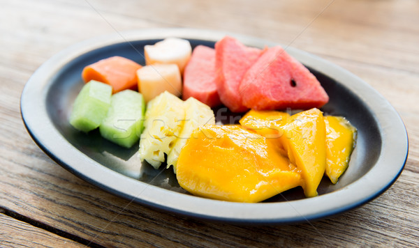 plate of fresh juicy fruits at asian restaurant Stock photo © dolgachov