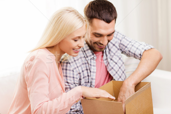 happy couple with parcel box at home Stock photo © dolgachov