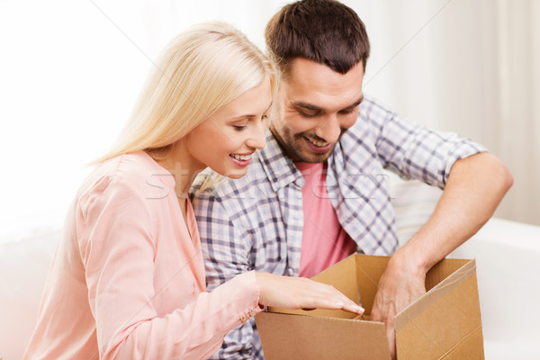 happy couple with parcel box at home Stock photo © dolgachov