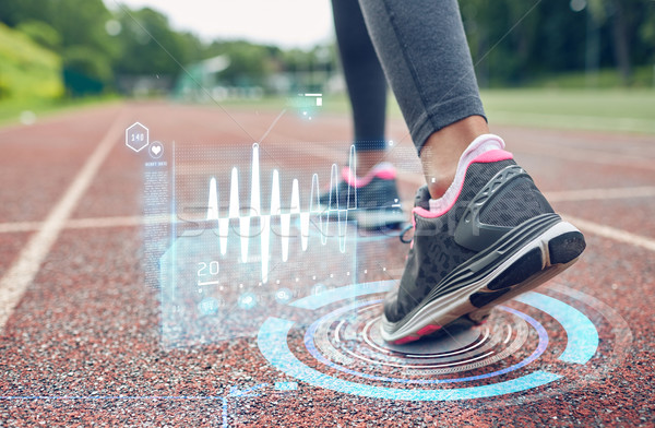 close up of woman feet running on track Stock photo © dolgachov