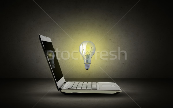 open laptop computer with lighting bulb Stock photo © dolgachov