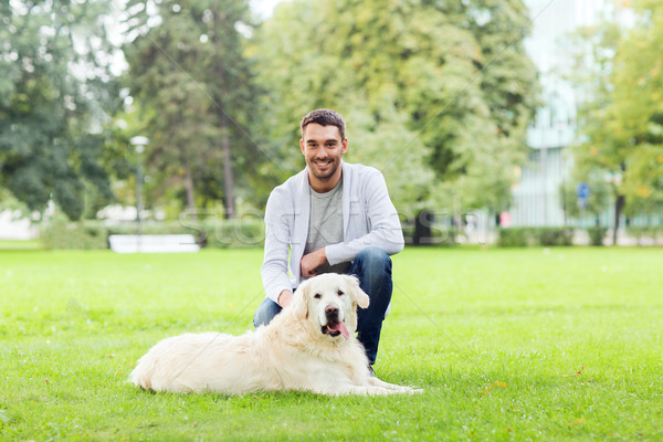 happy man with labrador dog walking in city Stock photo © dolgachov