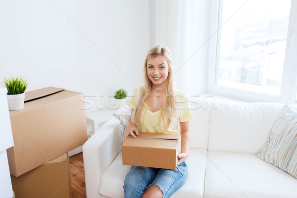 smiling young woman with cardboard box at home Stock photo © dolgachov
