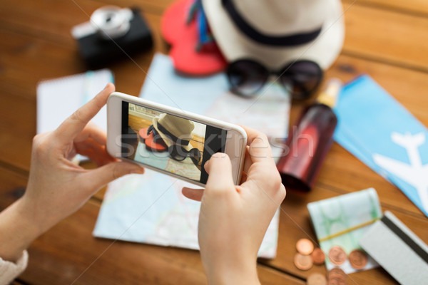 close up of woman with smartphone and travel stuff Stock photo © dolgachov