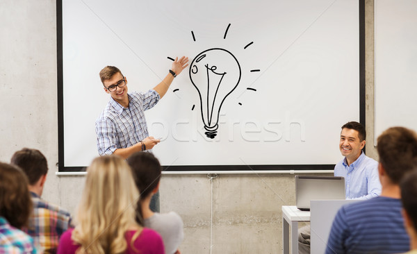 group of students and teacher at white board Stock photo © dolgachov