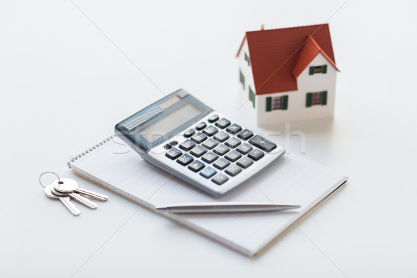 close up of home model, calculator and notebook Stock photo © dolgachov