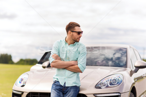 happy man standing at car outdoors Stock photo © dolgachov