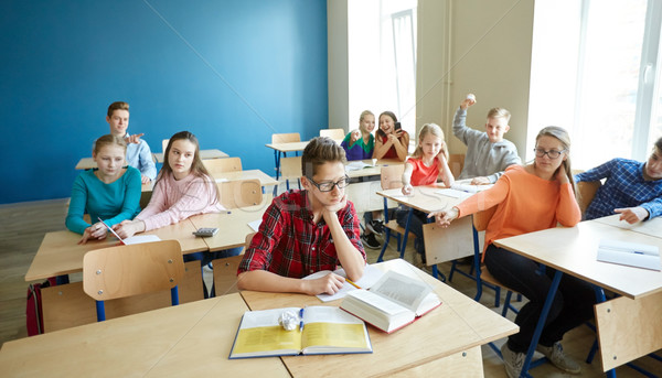 classmates laughing at student boy in school Stock photo © dolgachov