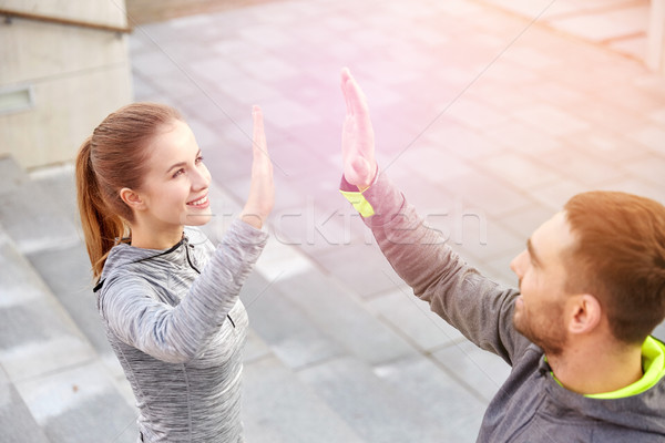 улыбаясь пару high five городской улице фитнес Сток-фото © dolgachov