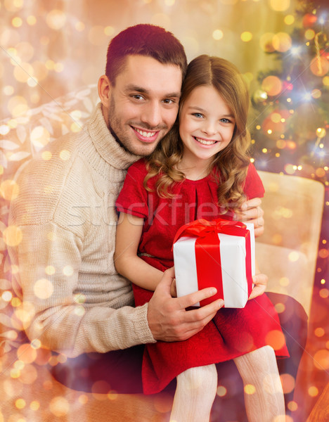 smiling father and daughter holding gift box Stock photo © dolgachov
