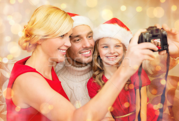 smiling family in santa helper hats taking picture Stock photo © dolgachov