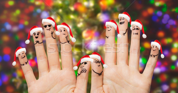 Közelkép ujjak emotikon mikulás sapkák karácsony Stock fotó © dolgachov