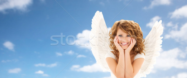 happy young woman or teen girl with angel wings Stock photo © dolgachov