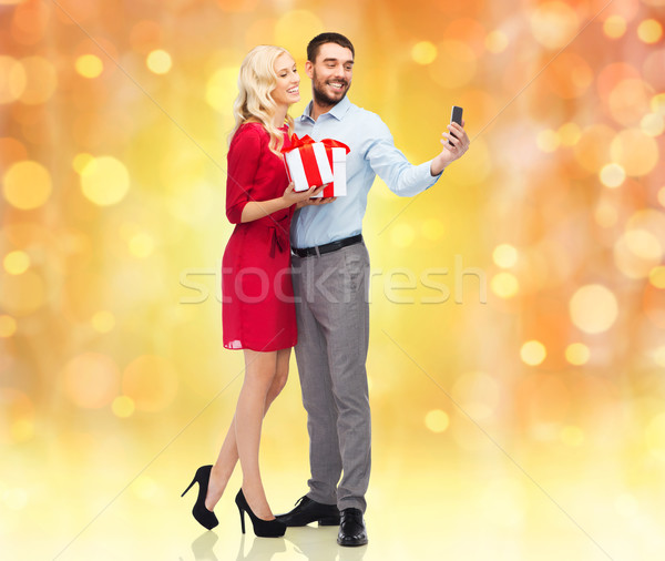 happy couple with smartphone and gift boxes Stock photo © dolgachov