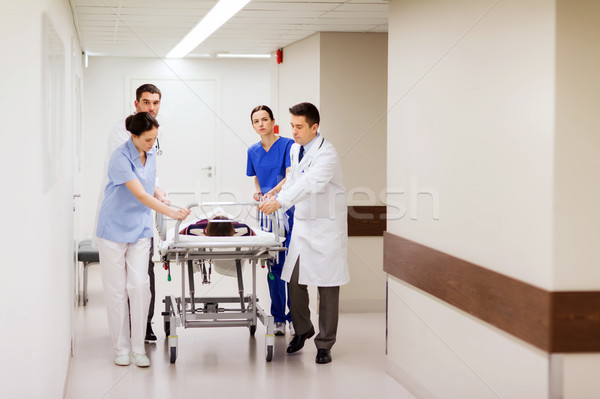 medics with woman on hospital gurney at emergency Stock photo © dolgachov