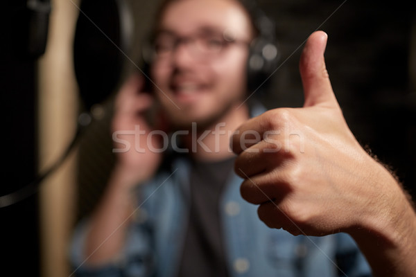 singer showing thumbs up at sound recording studio Stock photo © dolgachov