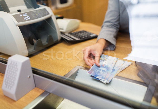 clerk with swiss francs cash money at bank office Stock photo © dolgachov