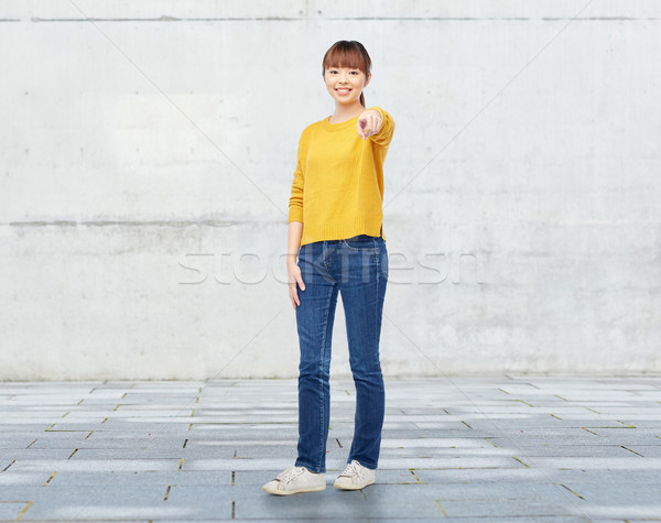 happy asian young woman pointing finger on you Stock photo © dolgachov