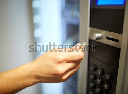 hand inserting euro coin to vending machine Stock photo © dolgachov