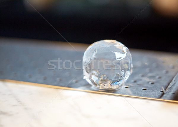 hand-cut ice ball at bar Stock photo © dolgachov