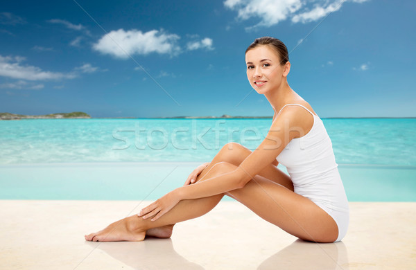 beautiful woman touching her legs on summer beach Stock photo © dolgachov
