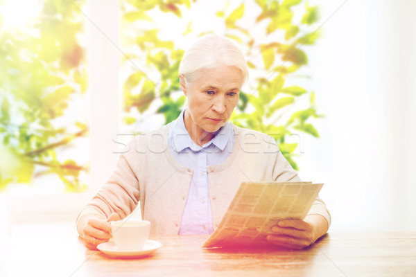 senior woman with coffee reading newspaper Stock photo © dolgachov