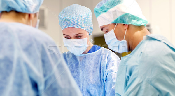 group of surgeons in operating room at hospital Stock photo © dolgachov