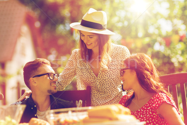 happy friends having dinner at summer garden party Stock photo © dolgachov