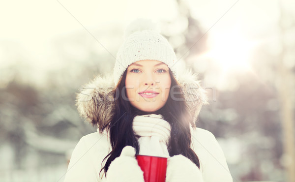 happy young woman with tea cup outdoors in winter Stock photo © dolgachov