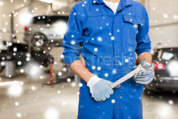 auto mechanic or smith with wrench at car workshop Stock photo © dolgachov