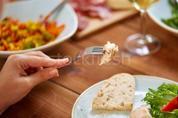 hand with chicken meat on fork Stock photo © dolgachov