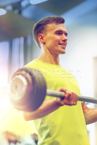 Lächelnd Mann Ausübung Langhantel Fitnessstudio Sport Stock foto © dolgachov