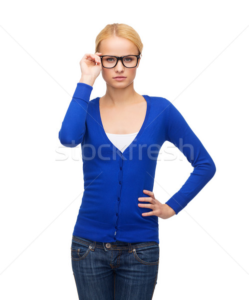 Stock photo: smiling woman in casual clothes wearing eyeglasses